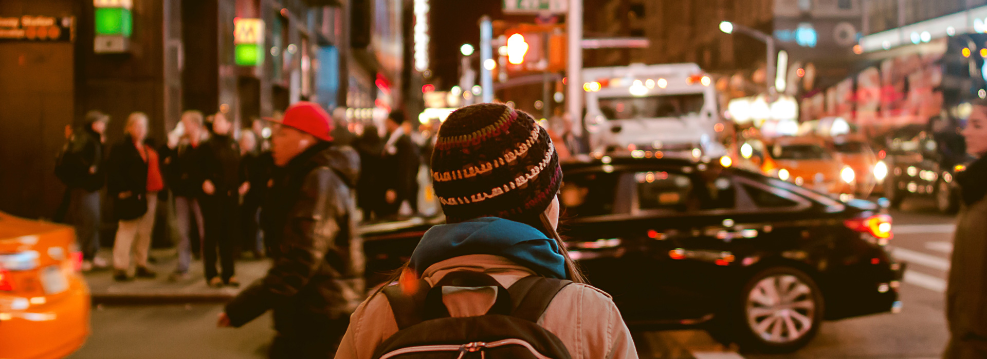 LIMAH girl walking on busy nyc street backpack ski hat